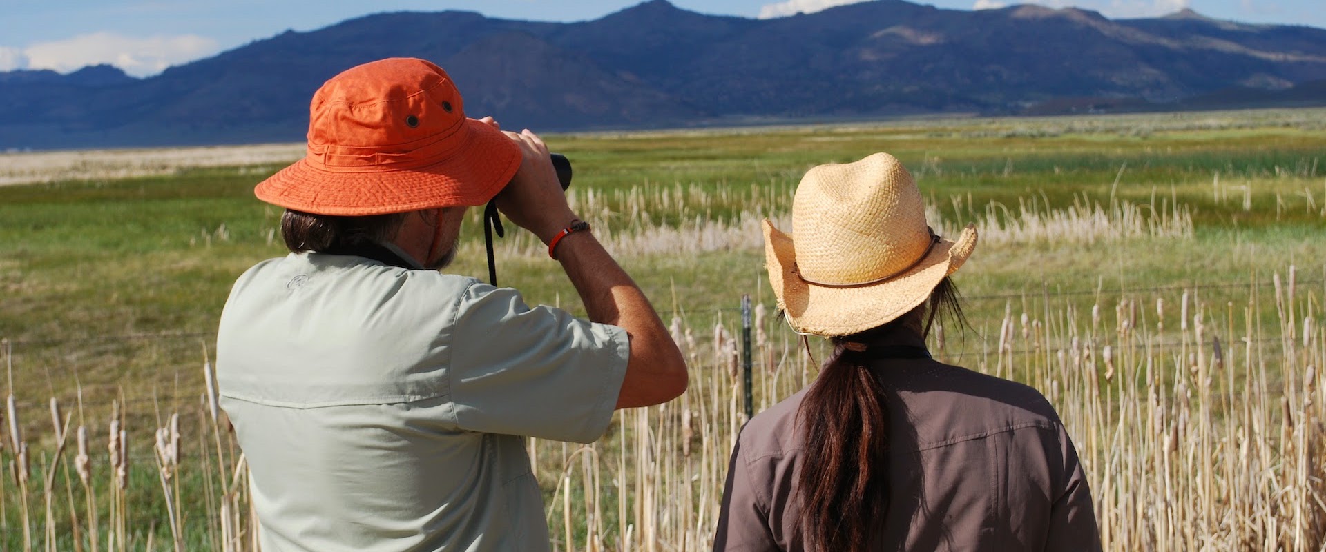 Couple looking through binoculars in Sierra Valley
