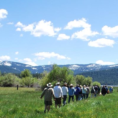 People walk on meadow trail at Mountain Meadows Gateway Preserve