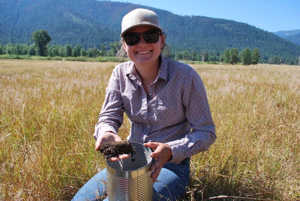 College intern takes soil samples at Heart K Ranch