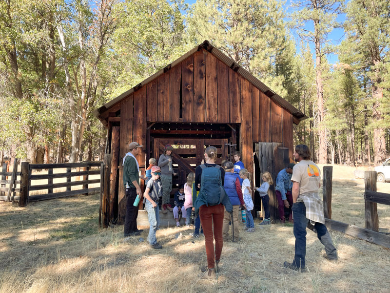 School group in front of historic weight station on the Heart K Ranch in Genesee Valley