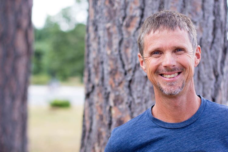 Rob Wade smiling in front of a tree