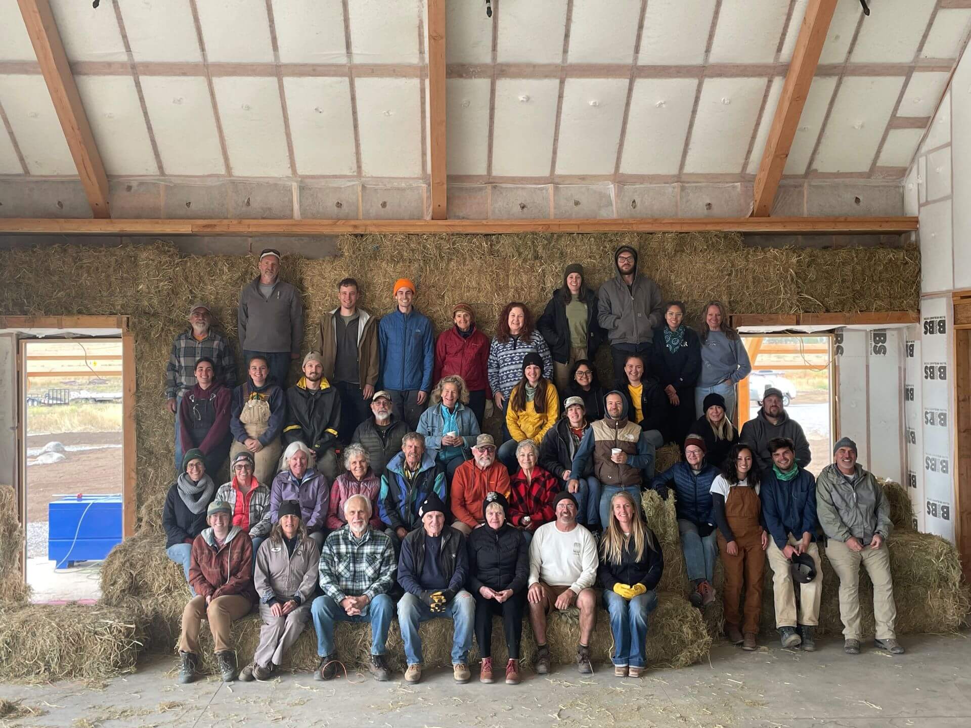 A large crew turned out to help insulate the new Nature Center with straw bales