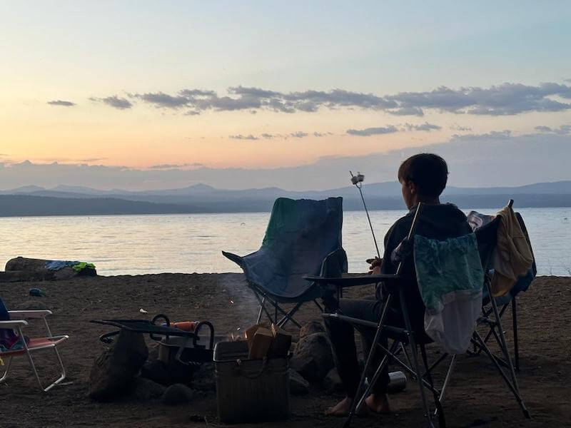 Boy roasts marshmallow while camping at Lake Almanor
